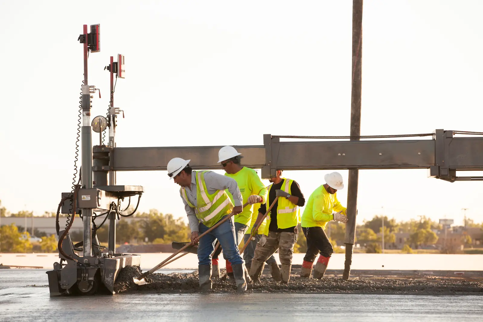 CEI crew leveling a commercial pour with a laser screed
